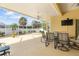 Screened lanai with seating area, dining table, and views of the landscaped backyard at 21820 Carson Dr, Land O Lakes, FL 34639