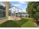 Screened patio with outdoor seating and a view of the lush backyard at 21820 Carson Dr, Land O Lakes, FL 34639