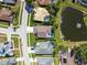 An aerial view of the residence, its screened pool, landscaping and pond at 22431 Willow Lakes Dr, Lutz, FL 33549