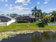Screened-in patio overlooking a serene pond provides a private backyard retreat at 22431 Willow Lakes Dr, Lutz, FL 33549