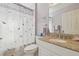 Bathroom featuring a vanity with a granite countertop, a mirror, and a shower with a dragonfly curtain at 22431 Willow Lakes Dr, Lutz, FL 33549