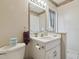Bathroom with vanity, commode, and floral wallpaper accent at 22431 Willow Lakes Dr, Lutz, FL 33549