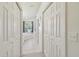 Bright bathroom hallway features a bathtub next to an arched window, as well as lots of storage at 22431 Willow Lakes Dr, Lutz, FL 33549