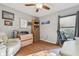 Bedroom featuring wood floors, a leather chair and a built in bookcase for storage at 22431 Willow Lakes Dr, Lutz, FL 33549
