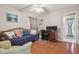Comfortable bedroom featuring wood floors, a ceiling fan, and a daybed with decorative pillows at 22431 Willow Lakes Dr, Lutz, FL 33549