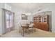 Bright dining area featuring a chandelier, natural light, and display cabinet at 22431 Willow Lakes Dr, Lutz, FL 33549