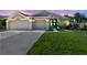 Charming single-story home with a well-manicured lawn, beautiful landscaping, and a three-car garage at 22431 Willow Lakes Dr, Lutz, FL 33549