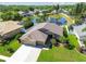 Aerial view of home, green lawn, landscaping, and peaceful pond in a residential neighborhood at 22431 Willow Lakes Dr, Lutz, FL 33549