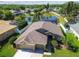 Home with manicured lawn, landscaping, and peaceful pond in a residential neighborhood at 22431 Willow Lakes Dr, Lutz, FL 33549