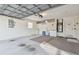 Spacious two car garage with white walls, storage area, and concrete floor at 22431 Willow Lakes Dr, Lutz, FL 33549