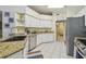 Bright kitchen featuring white cabinets, stainless steel appliances, and tile flooring at 22431 Willow Lakes Dr, Lutz, FL 33549