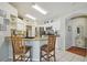 Well-lit kitchen with granite countertops, stainless steel appliances, breakfast bar, and white cabinetry at 22431 Willow Lakes Dr, Lutz, FL 33549