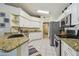 Bright kitchen with granite countertops, stainless steel appliances, and white cabinetry at 22431 Willow Lakes Dr, Lutz, FL 33549