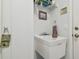 Utility sink with storage rack and Yosemite hiking decor in the laundry room at 22431 Willow Lakes Dr, Lutz, FL 33549