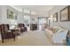Cozy living room features a fireplace, comfortable seating, neutral decor and a view to another room at 22431 Willow Lakes Dr, Lutz, FL 33549