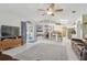 Open-concept living room boasting tile floors, neutral colors, and a ceiling fan at 22431 Willow Lakes Dr, Lutz, FL 33549