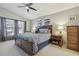 Spacious main bedroom with a large window, ceiling fan, and stylish decor providing a relaxing atmosphere at 22431 Willow Lakes Dr, Lutz, FL 33549