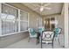 Outdoor patio area with table and chairs, ceiling fan, and decorative curtains at 22431 Willow Lakes Dr, Lutz, FL 33549