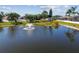Scenic view of a pond with a fountain surrounded by lush greenery in a residential community at 22431 Willow Lakes Dr, Lutz, FL 33549