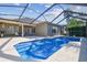 Beautiful backyard pool area with screened enclosure, outdoor furniture, and well-maintained landscaping at 22431 Willow Lakes Dr, Lutz, FL 33549