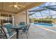 Relaxing screened-in patio, pool, and backyard with beautiful landscaping and water view at 22431 Willow Lakes Dr, Lutz, FL 33549