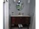 Bathroom vanity with marble countertop and oval mirror at 3207 Jarvis St, Holiday, FL 34690