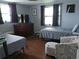 Cozy bedroom features two twin beds, wood floors, and dual windows for natural light at 3207 Jarvis St, Holiday, FL 34690