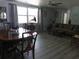 Bright and airy dining area with hardwood floors, traditional furniture, and views of the adjacent living space at 3207 Jarvis St, Holiday, FL 34690