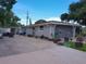Spacious home with a large driveway, lush landscaping, and mature trees providing ample shade at 3207 Jarvis St, Holiday, FL 34690