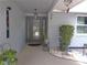 Charming front door entrance with decorative glass, hanging lantern, and potted plants at 3207 Jarvis St, Holiday, FL 34690