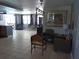 Spacious open-concept living area with tile floors, neutral walls, and modern light fixtures at 3207 Jarvis St, Holiday, FL 34690