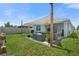 Spacious backyard featuring a shaded patio area with outdoor furniture and well-manicured lawn at 33592 Barberry Leaf Way, Wesley Chapel, FL 33543