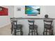 Close-up of the bar with comfortable seating and a clear view of the entertainment setup at 33592 Barberry Leaf Way, Wesley Chapel, FL 33543