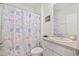 Bathroom with seashell-themed shower curtain and granite countertop at 33592 Barberry Leaf Way, Wesley Chapel, FL 33543