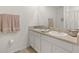 Well-lit bathroom with double sinks, a neutral color scheme, and modern fixtures at 33592 Barberry Leaf Way, Wesley Chapel, FL 33543