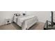 Cozy bedroom featuring a queen bed with patterned bedding and a minimalist white nightstand at 33592 Barberry Leaf Way, Wesley Chapel, FL 33543