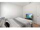 This bedroom includes a decorative comforter and modern TV for a relaxing personal space at 33592 Barberry Leaf Way, Wesley Chapel, FL 33543