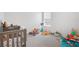 Bright Bedroom with a crib, organized toys, and ample space for play at 33592 Barberry Leaf Way, Wesley Chapel, FL 33543