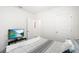 This bedroom includes a modern TV, and is situated between two doorways at 33592 Barberry Leaf Way, Wesley Chapel, FL 33543