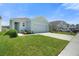 Well-maintained home with a manicured lawn and a driveway, showcasing its appealing curb appeal and neighborhood setting at 33592 Barberry Leaf Way, Wesley Chapel, FL 33543