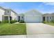 Charming single-Gathering home featuring a well-manicured lawn and a two-car garage in a suburban neighborhood at 33592 Barberry Leaf Way, Wesley Chapel, FL 33543