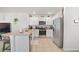 Bright kitchen with stainless steel appliances, granite countertops and white cabinetry at 33592 Barberry Leaf Way, Wesley Chapel, FL 33543