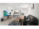 Open-concept living area featuring a modern kitchen and a comfortable seating arrangement at 33592 Barberry Leaf Way, Wesley Chapel, FL 33543