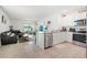 Open concept living and kitchen area with stainless steel appliances and tile flooring at 33592 Barberry Leaf Way, Wesley Chapel, FL 33543