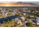 Gorgeous aerial view of waterfront homes with boat docks on canals leading to the ocean at sunset at 3546 Flamingo Blvd, Hernando Beach, FL 34607