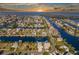 Spectacular aerial shot captures a sunset view of the waterfront home nestled in a coastal canal community at 3546 Flamingo Blvd, Hernando Beach, FL 34607