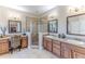 Spacious bathroom featuring a tiled shower, double sinks, vanity area, and decorative mirrors at 3546 Flamingo Blvd, Hernando Beach, FL 34607