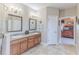 Bright bathroom with double sinks, wood cabinets, and decorative nautical accents creates a calming atmosphere at 3546 Flamingo Blvd, Hernando Beach, FL 34607
