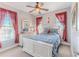 Serene bedroom featuring white furniture, a ceiling fan, and large windows with ample natural light at 3546 Flamingo Blvd, Hernando Beach, FL 34607