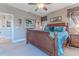 Bedroom featuring a decorative bed, carpet flooring, and a picturesque view of the outside through curtained windows at 3546 Flamingo Blvd, Hernando Beach, FL 34607